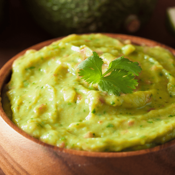 guacamole dip in a wooden bowl