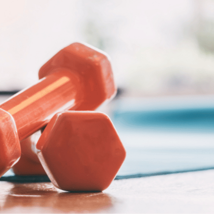 orange dumbbells on the floor