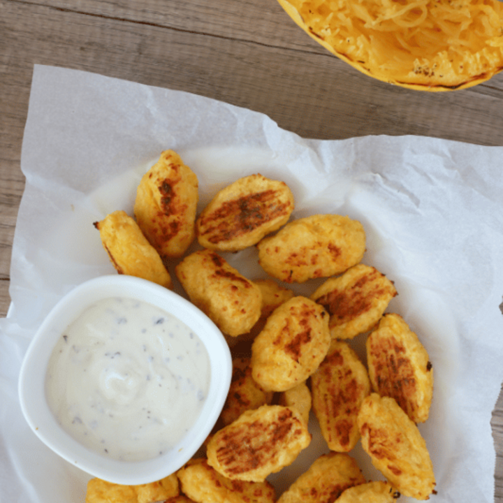 spaghetti squash bites on a plate with dipping sauce