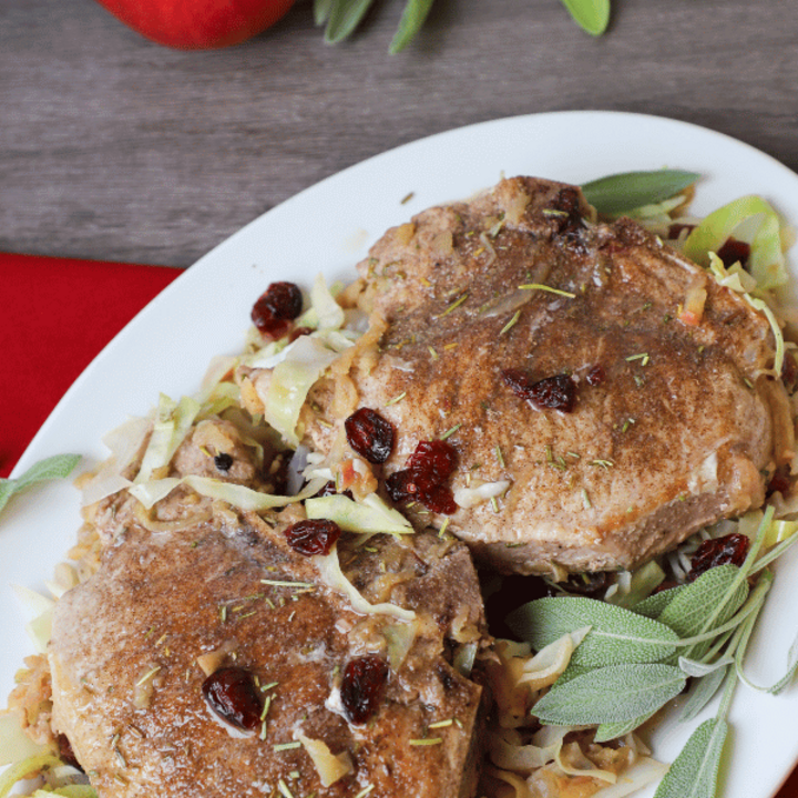 Two pork chops on a plate with cabbage