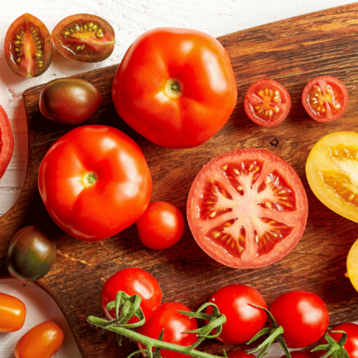 variety of colorful tomatoes on a cutting board