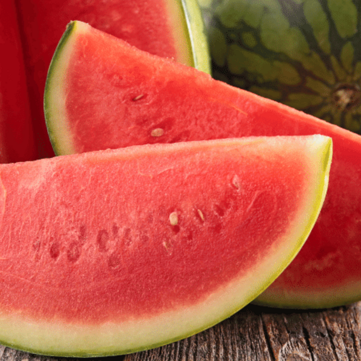 sliced watermelon on a wood table