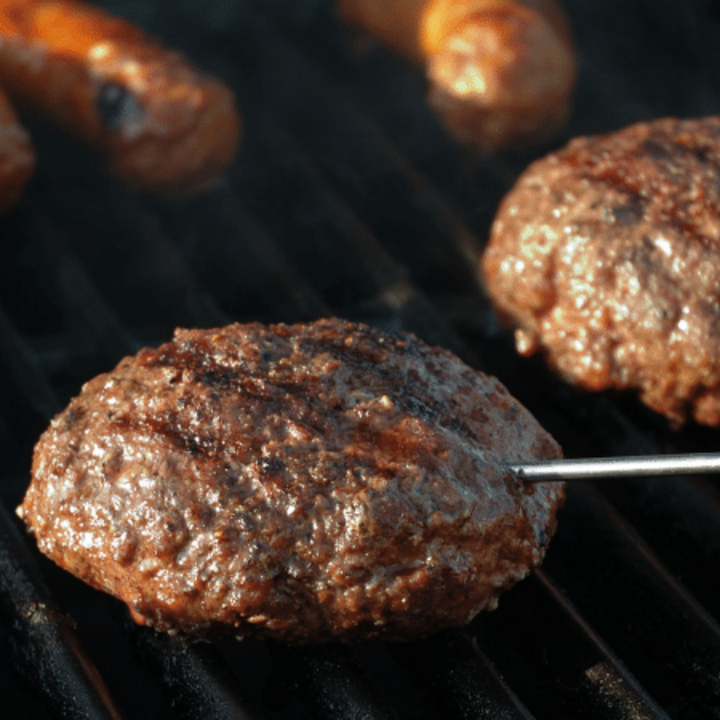 grilling hamburgers and hot dogs with food thermometer