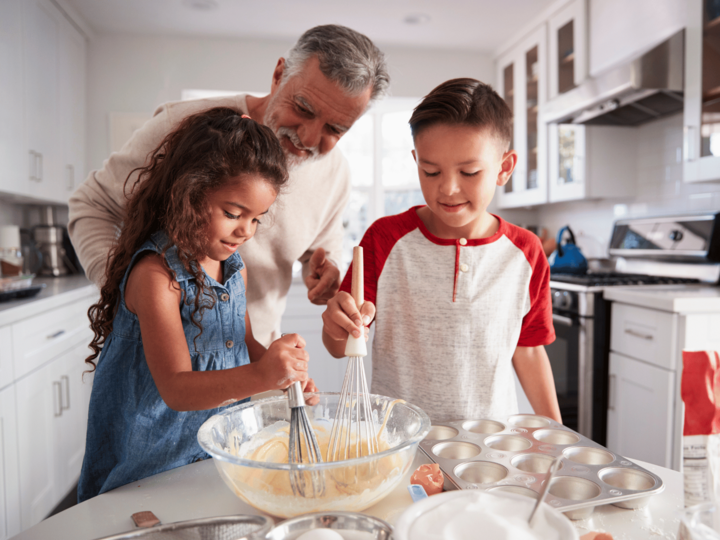 girl and boy baking with grandpa