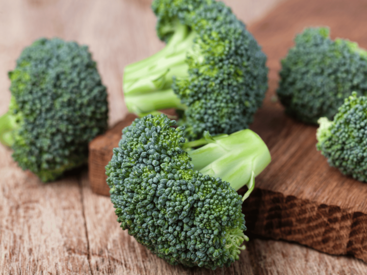 pieces of broccoli on a cutting board