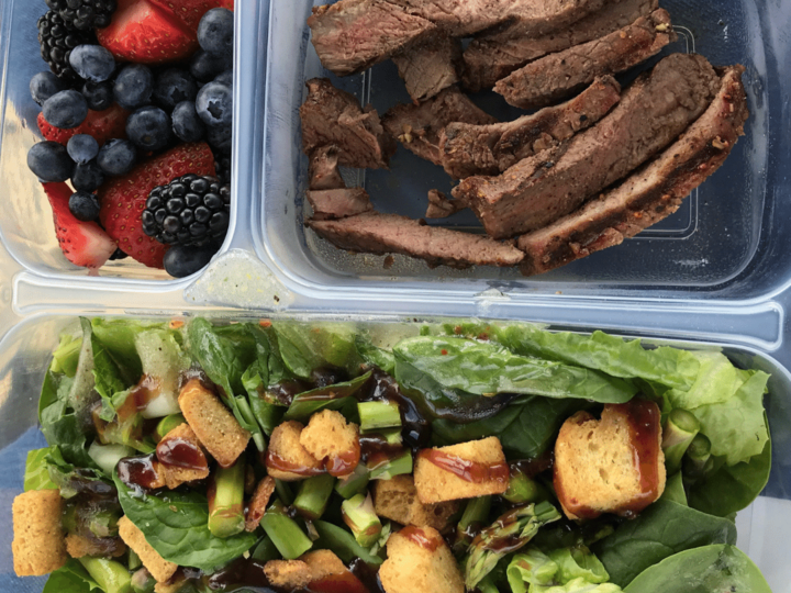 on the go lunch that includes steak, salad, and berries