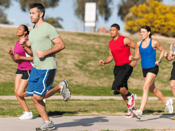 group of adults running on a trail