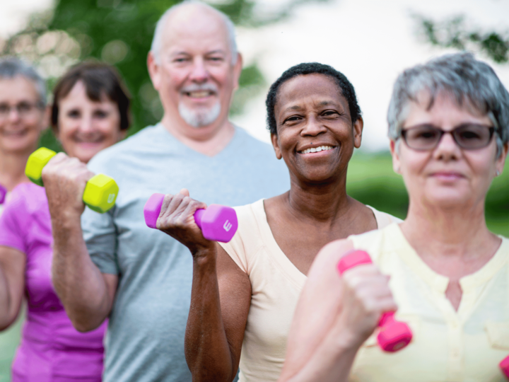 group of older adults lifting dumbbells