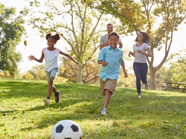 family playing soccer together