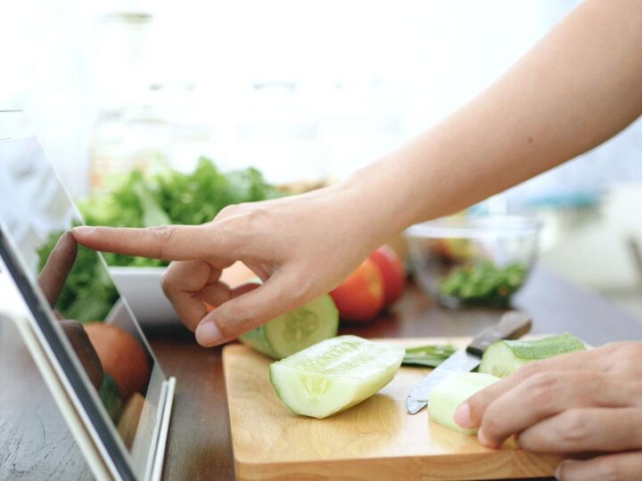 Person using an iPad in the kitchen.