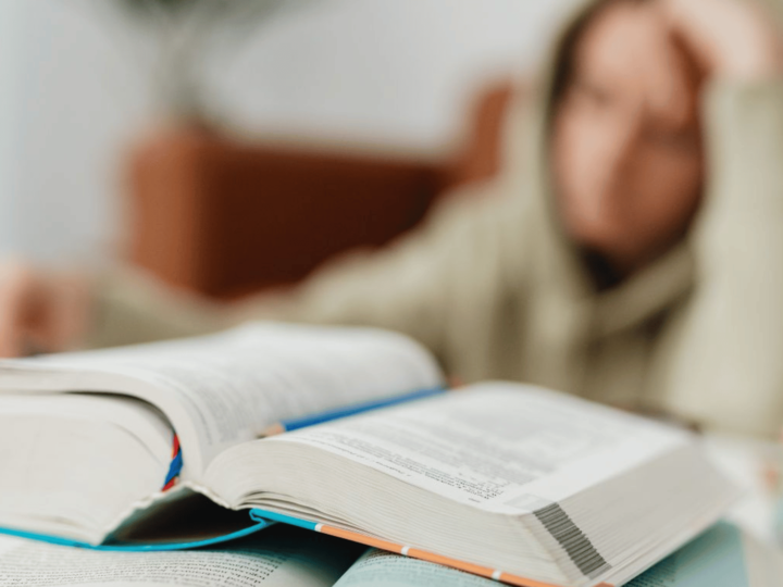 sleepy high school student trying to read a book