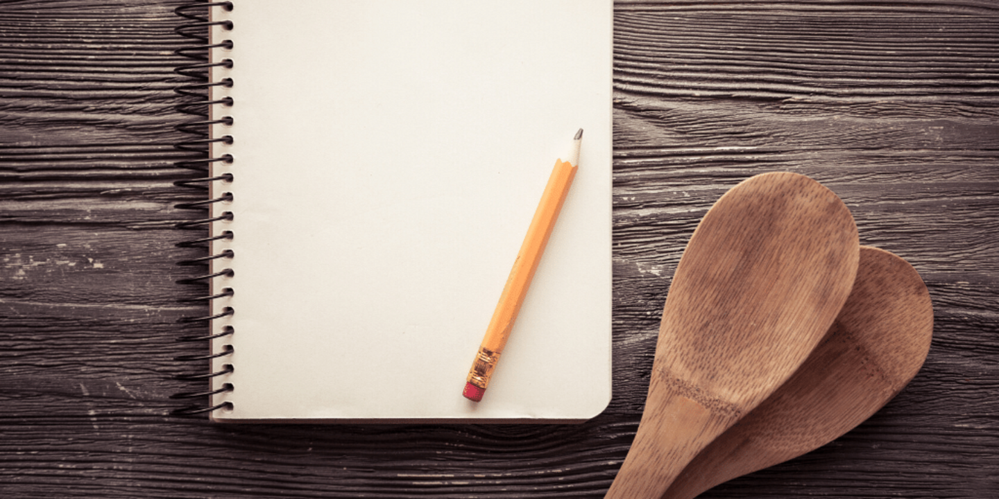 notebook with pencil for reducing size of recipes and cooking utensils