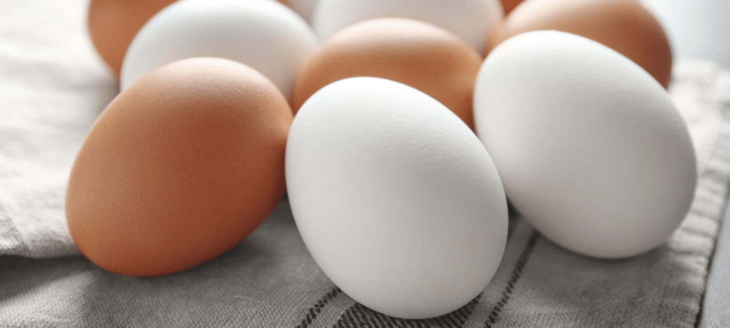 brown and white eggs on a table cloth