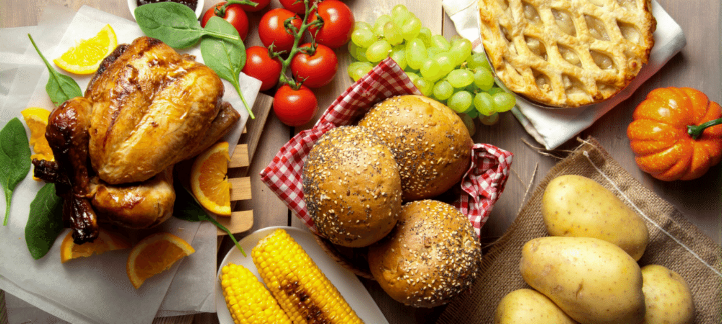 holiday meal with turkey, fresh produce, whole grain bread, and pie