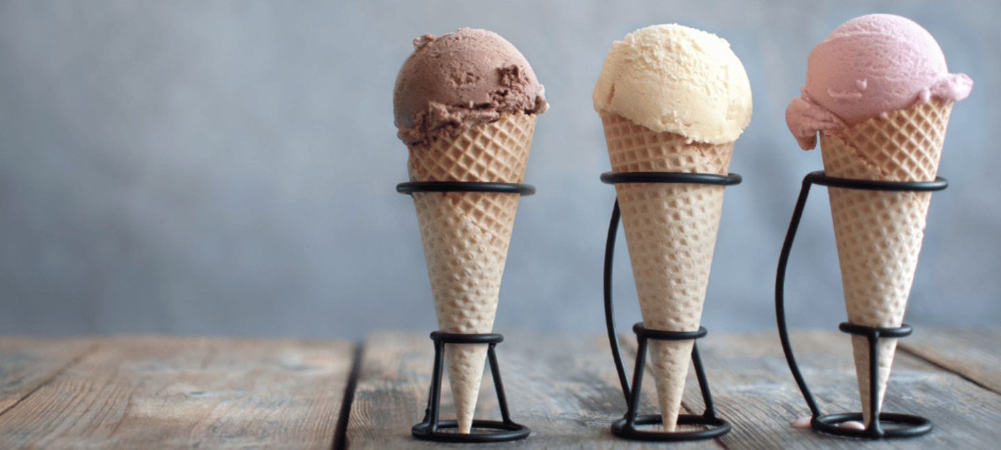 homemade chocolate, vanilla, and strawberry ice cream in ice cream cones