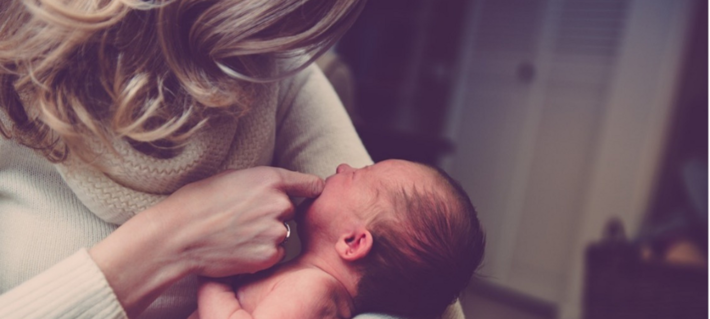 mother holding baby