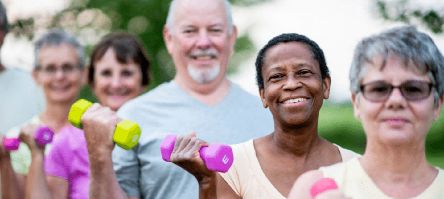 older adults lifting dumbbells