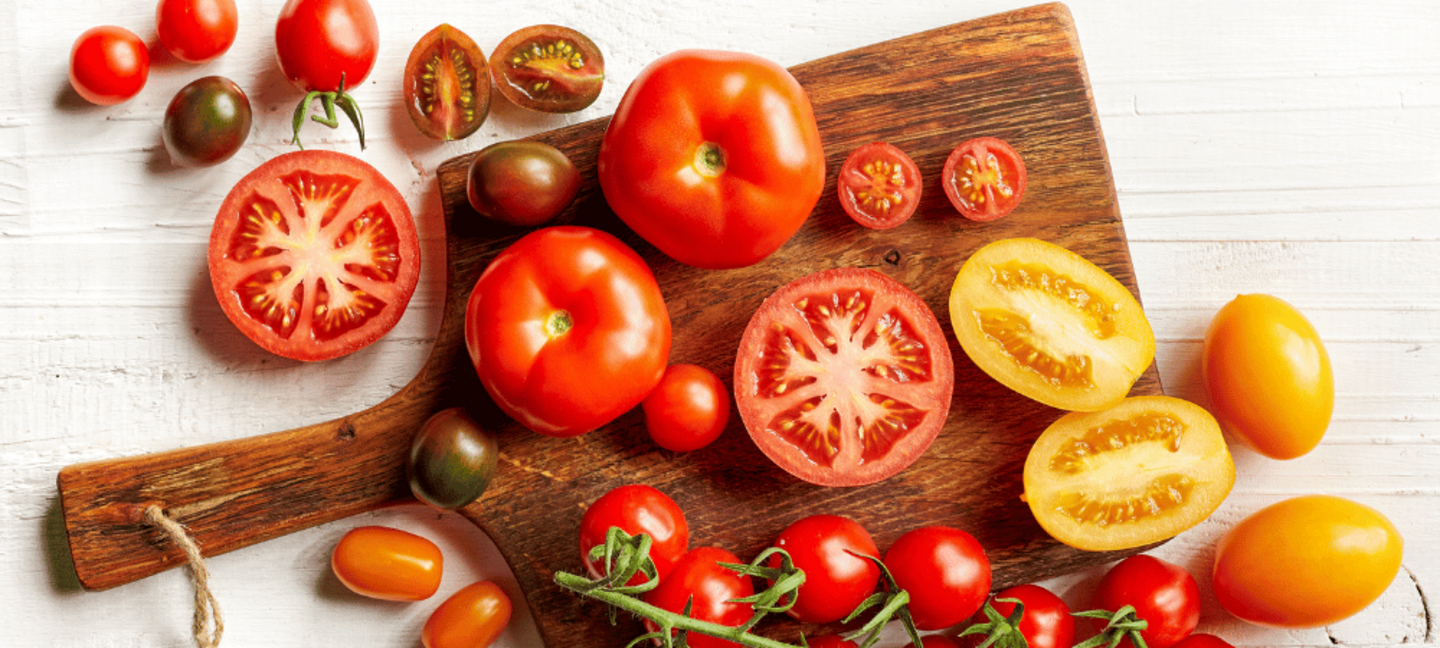 variety of colorful tomatoes on a cutting board