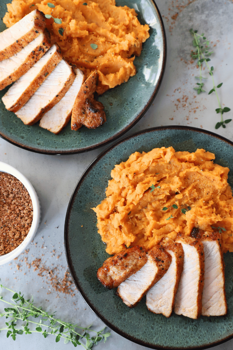 Sliced pork chops with mashed sweet potatoes on a plate