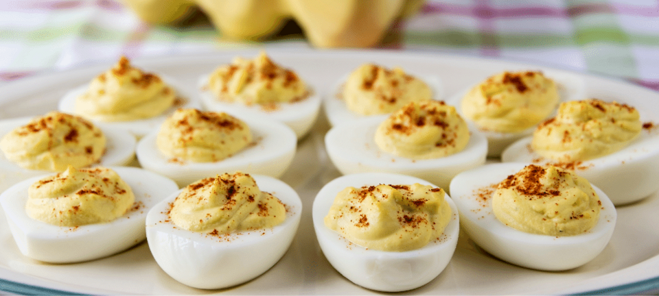 deviled eggs with paprika on a plate