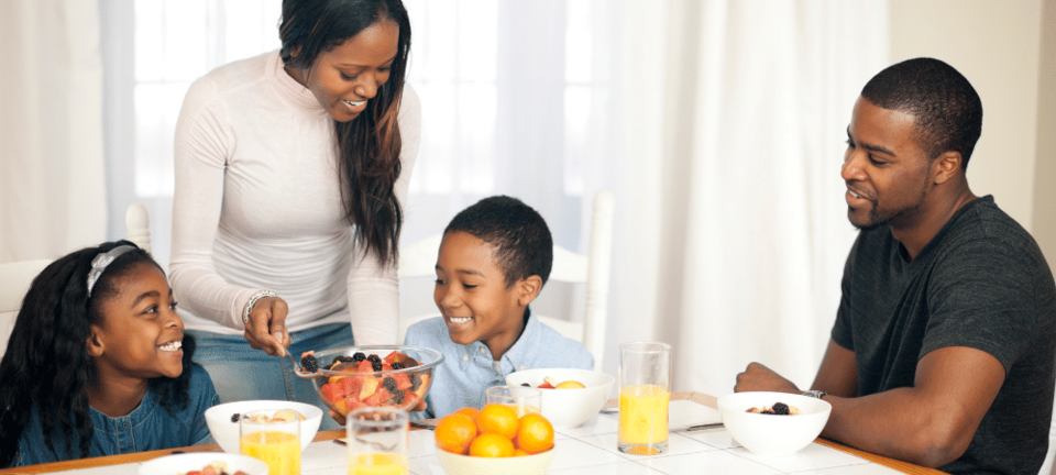 family sitting together at kitchen table for a meal