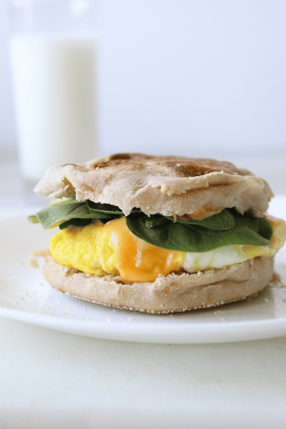 Egg and cheese muffin with a glass of milk