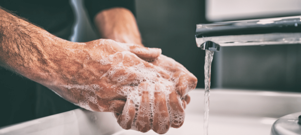 man washing hands with soap and water