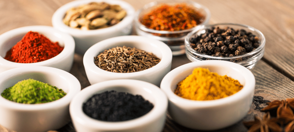 variety of herbs and spices in bowls