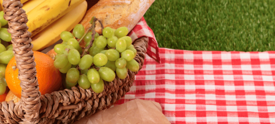 basket of fruit and bread for a summer picnic