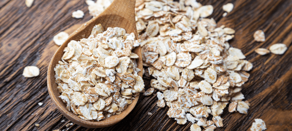 raw oatmeal in a spoon on a table