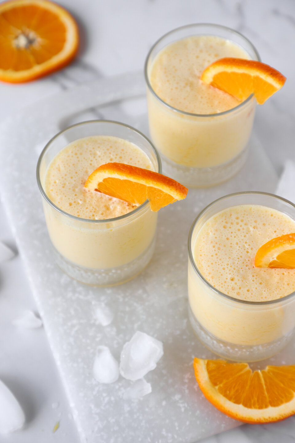 orange slushie in glass cups