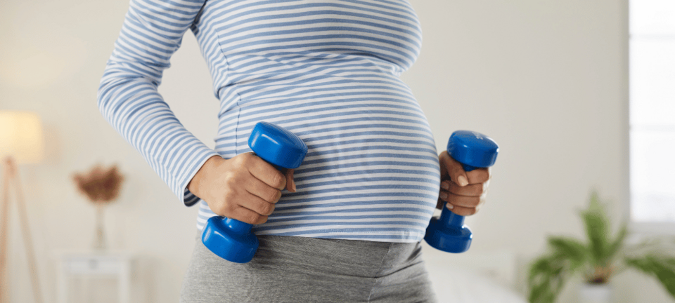 pregnant woman with dumbbells