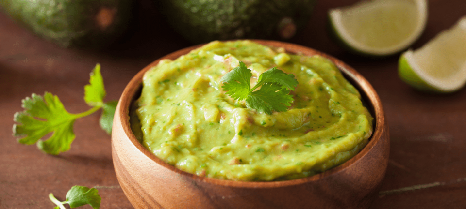 guacamole dip in a wooden bowl