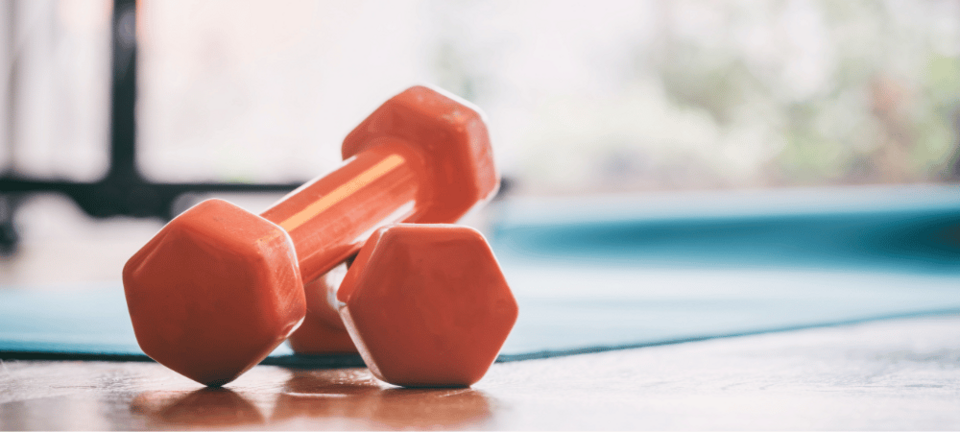 orange dumbbells on the floor