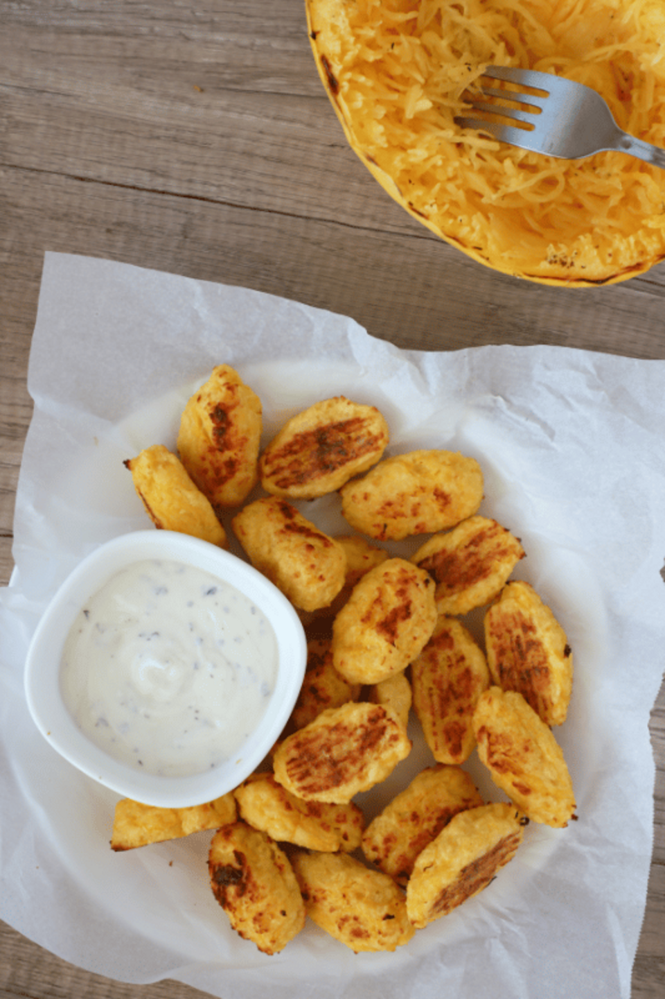 spaghetti squash bites on a plate with dipping sauce