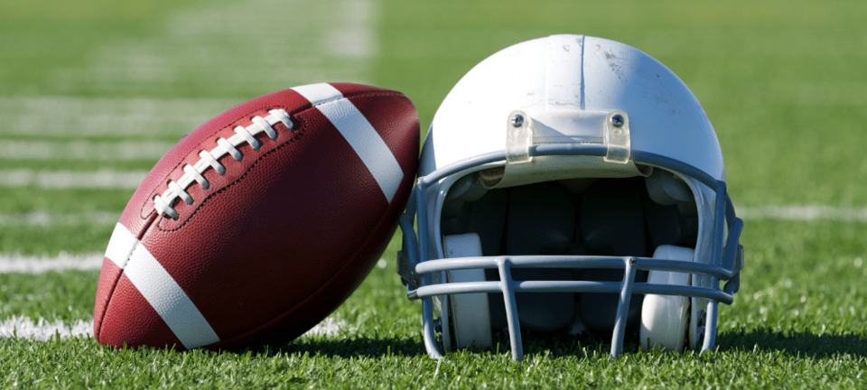 football and helmet on the field