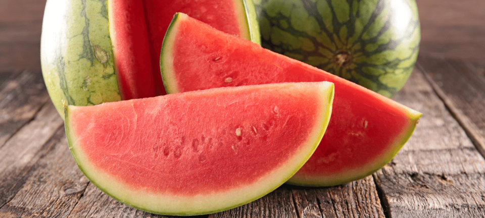 sliced watermelon on a wood table