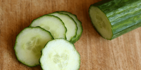 sliced cucumber on cutting board