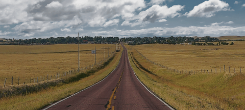 scenic road in Nebraska with fields on each side