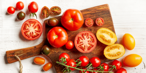 variety of colorful tomatoes on a cutting board