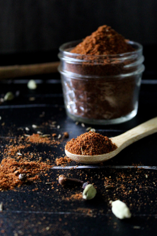 Baharat spice blend in glass jar and on the spoon