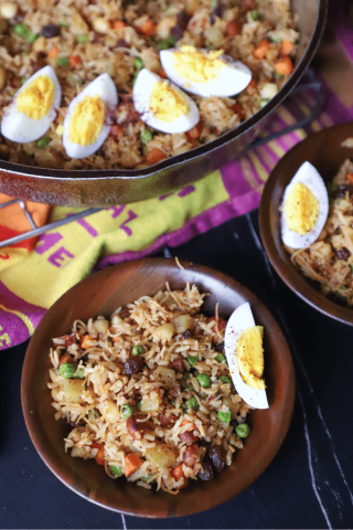 Biryani with eggs in 2 bowls and a skillet