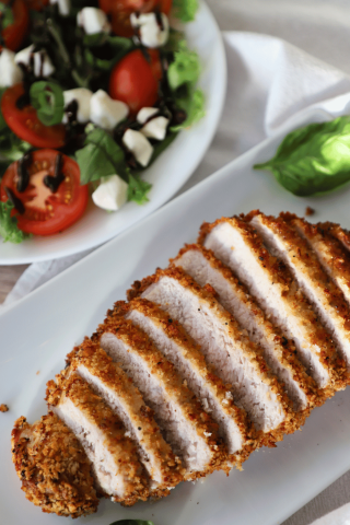 Crispy pork chop, sliced with salad