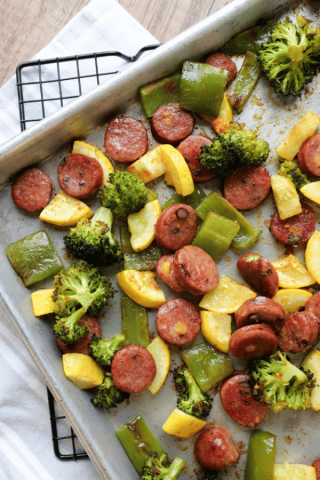 Sausage, bell peppers, summer squash and broccoli on a sheet pan